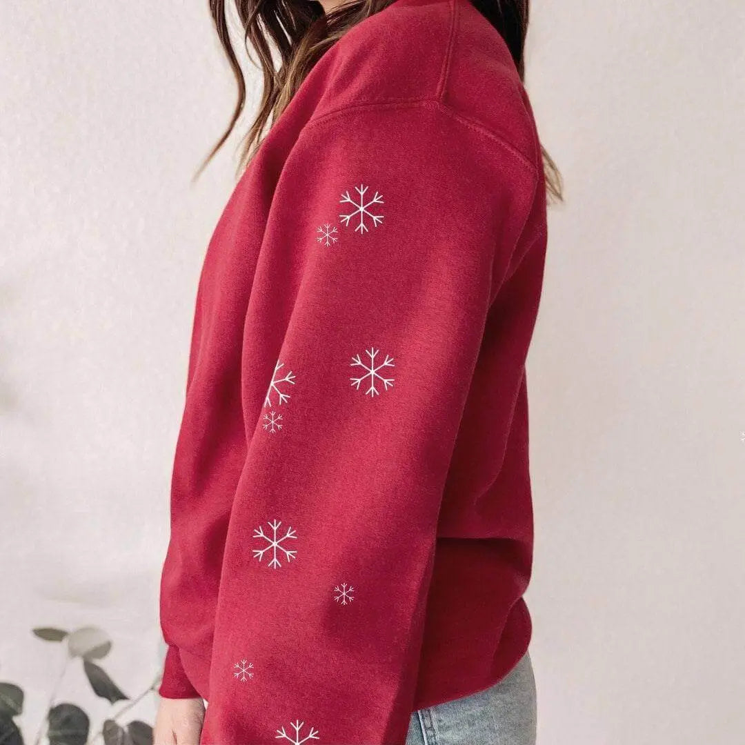 Winks Design Studio LLC Let It Snow long sleeve shirt with festive snowflake design on white fabric.