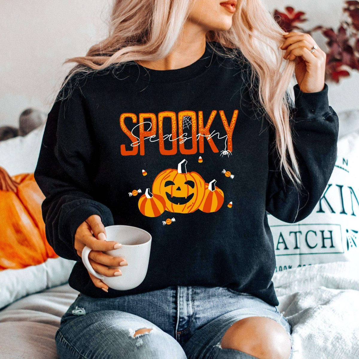Winks Design Studio LLC Spooky Season long sleeve shirt featuring Halloween-themed graphics on black fabric.