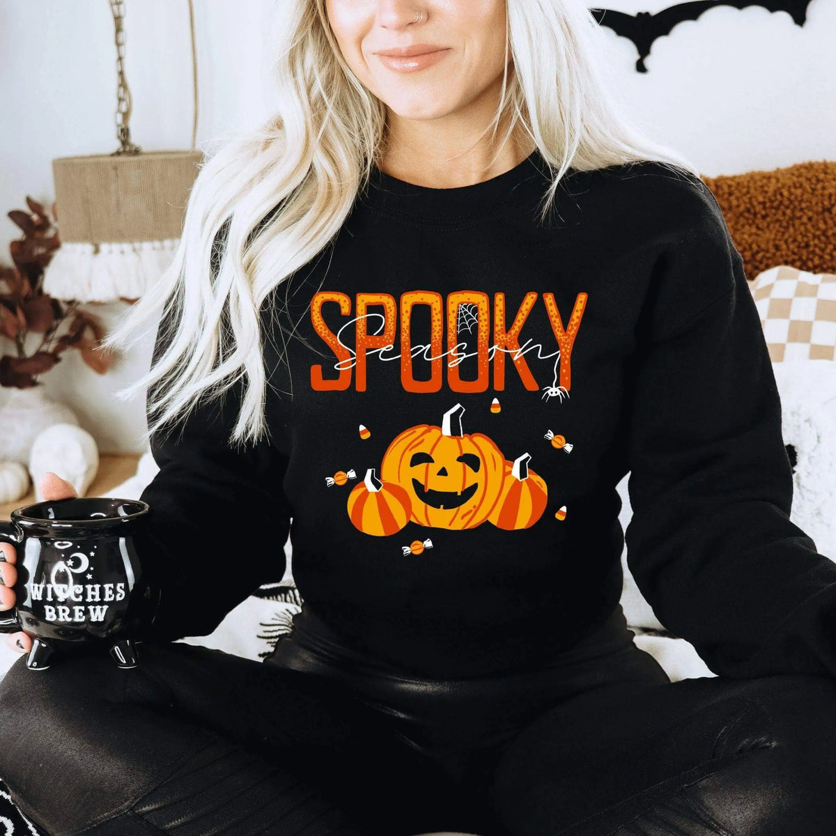 Winks Design Studio LLC Spooky Season long sleeve shirt featuring Halloween-themed design in black and orange.