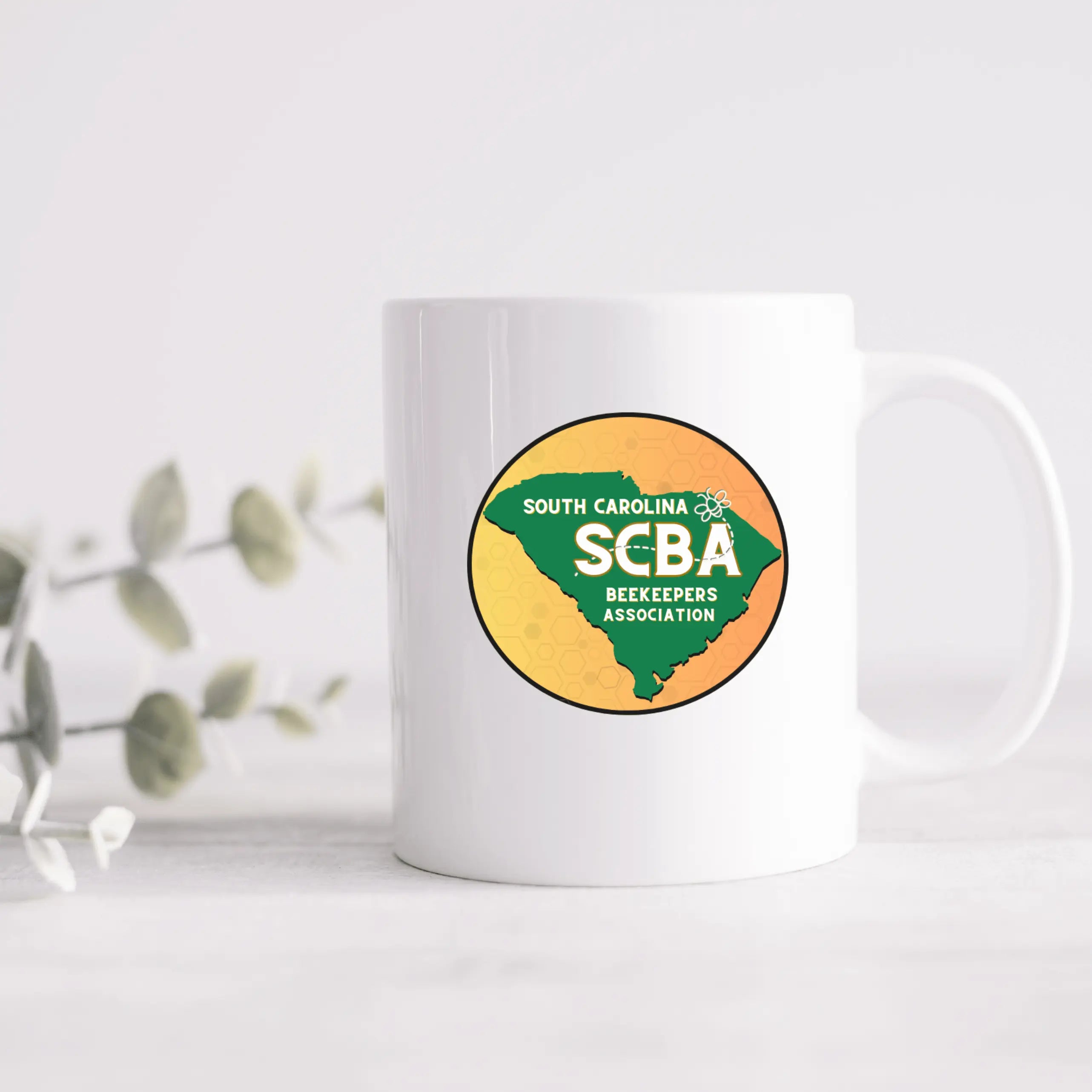 Winks Design Studio LLC SCBA Ceramic Mug with black handle, featuring a bold, modern design on white ceramic surface.