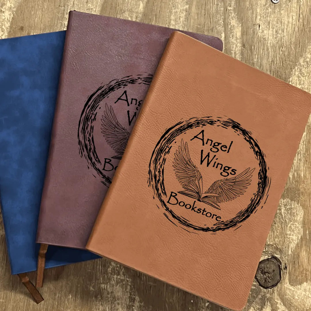 Blue leather Angel Wings Bookstore Notebook by Winks Design Studio, LLC featuring angel wing details and a stylish journal cover.