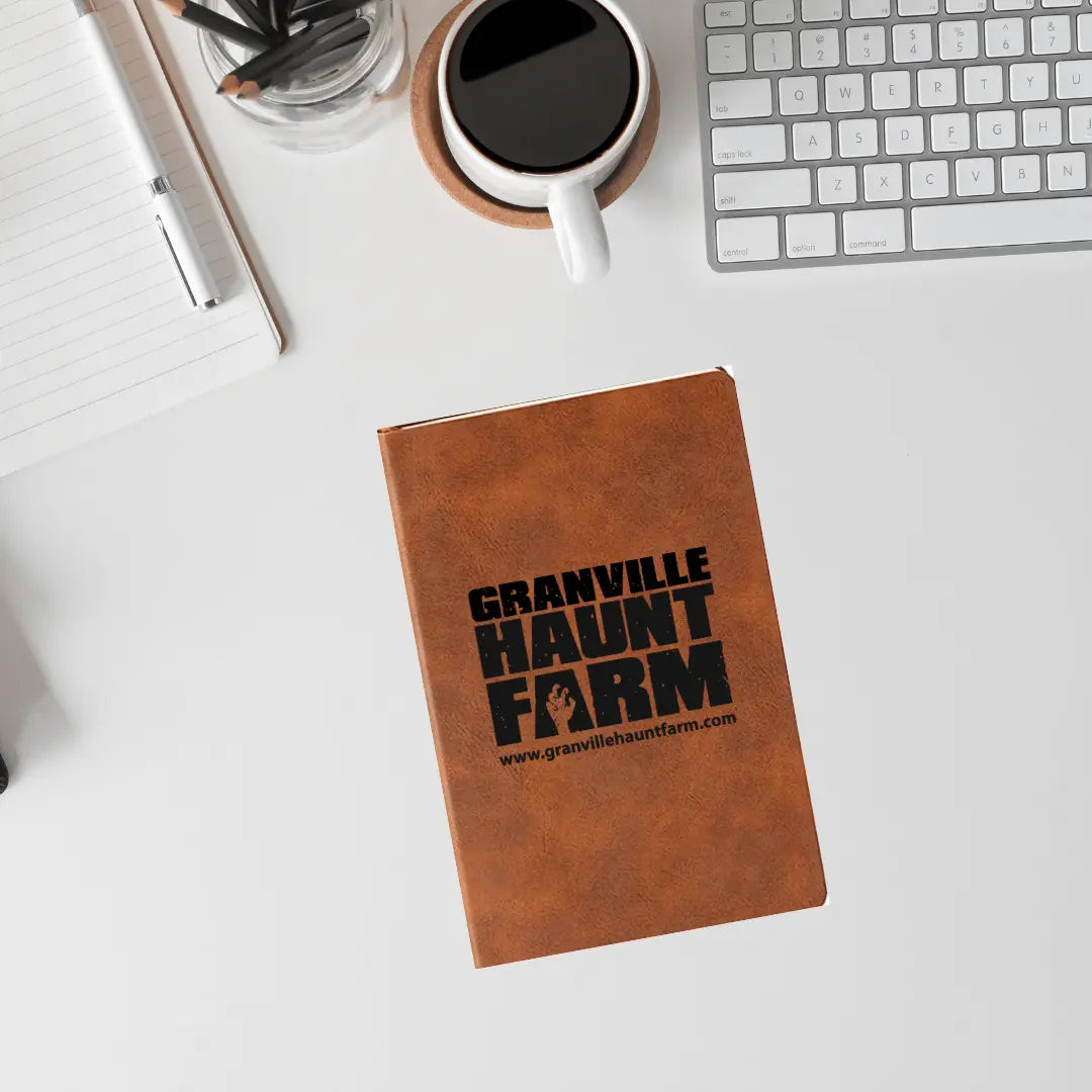 Granville Haunt Farm leather journal by Winks Design Studio, LLC, featuring a rustic leather cover and vintage-style pages.