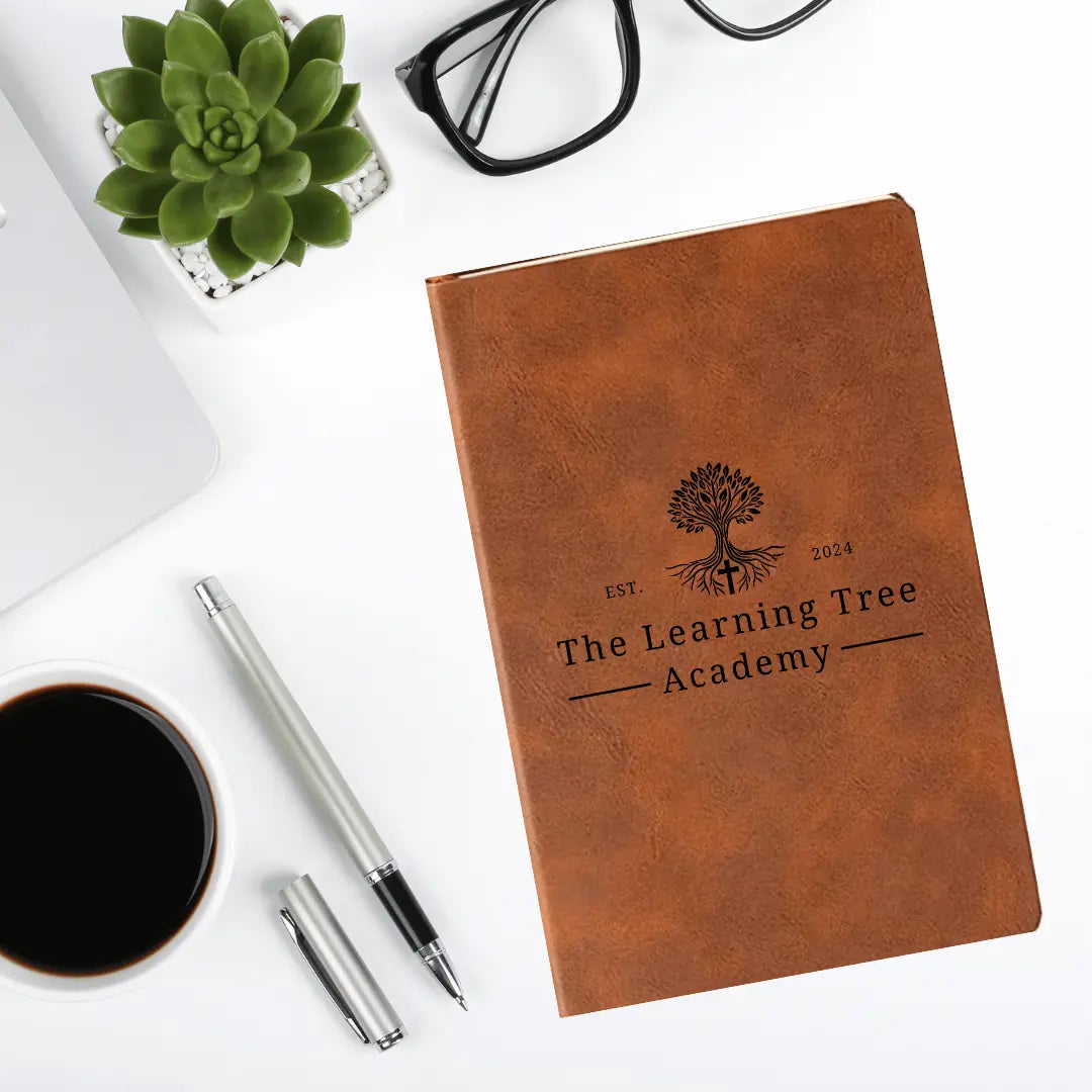 Winks Design Studio LLC leather journal from The Learning Tree Academy, featuring a textured cover and lined pages for writing.