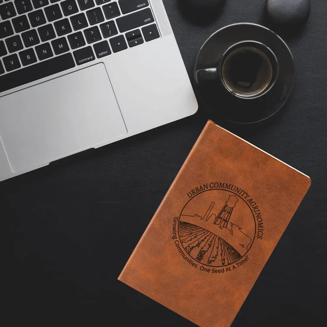 Winks Design Studio LLC UCAN leather journal notebook with textured brown leather cover and elastic closure.