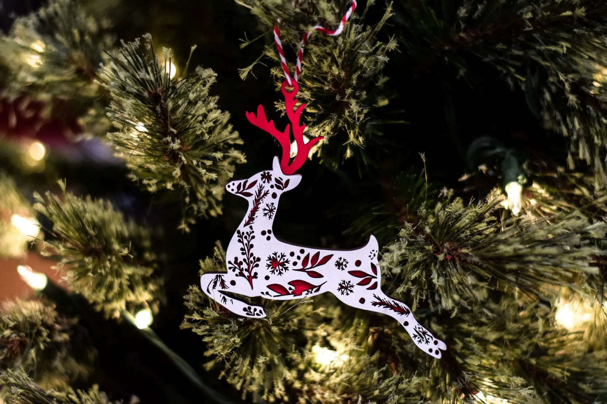 Festive Reindeer Christmas ornament by Winks Design Studio, LLC, featuring a detailed reindeer design for holiday decoration.