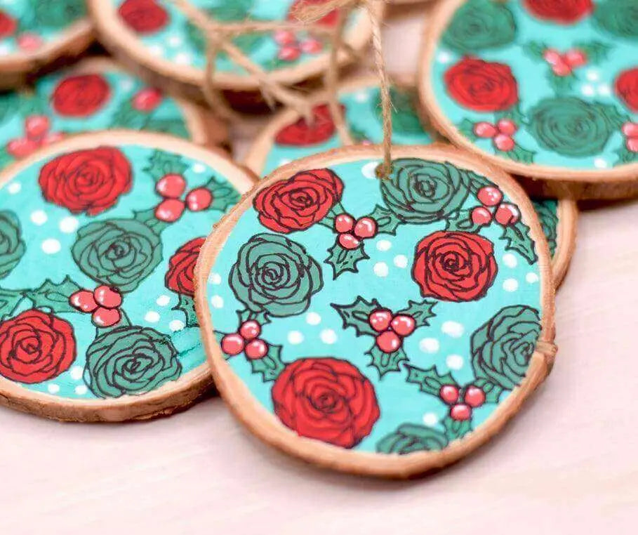 Hand-painted wooden Christmas ornament featuring red roses, crafted by Winks Design Studio, LLC, for festive holiday decor.