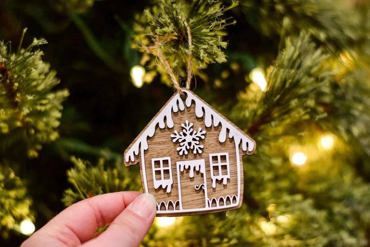Wooden gingerbread house ornament by Winks Design Studio, LLC, featuring detailed craftsmanship and festive holiday design.