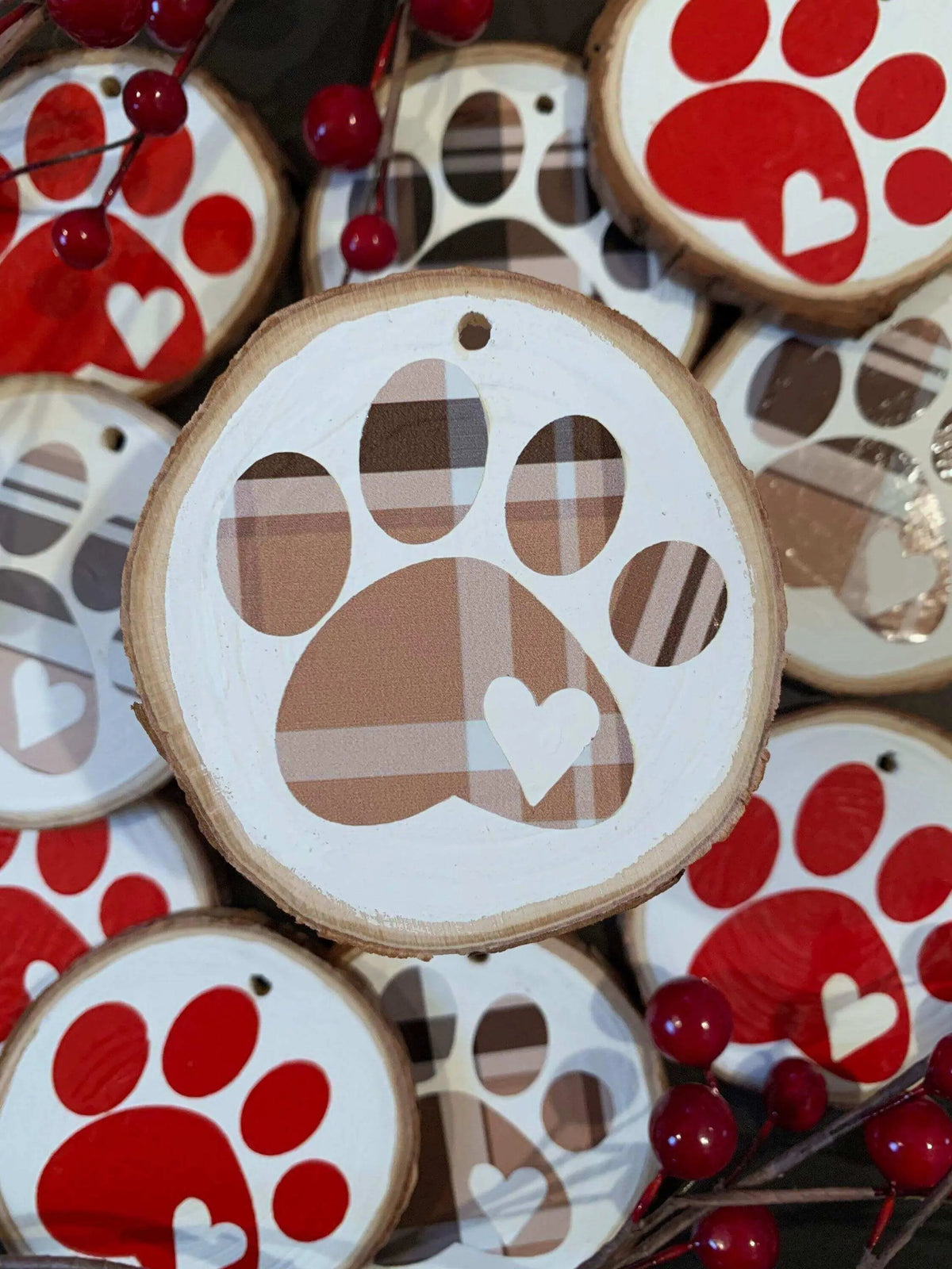 Brown plaid Christmas tree ornament with a paw print design by Winks Design Studio, LLC, perfect for holiday decorating.