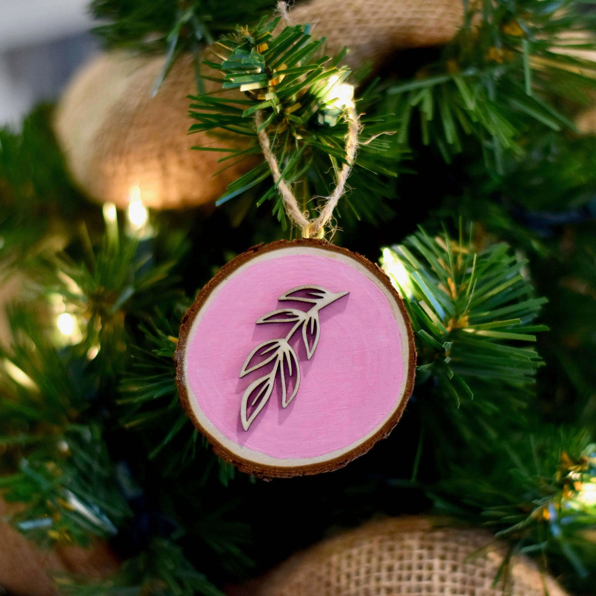 Red wooden floral ornament by Winks Design Studio, LLC, featuring intricate carved floral patterns in natural wood finish.