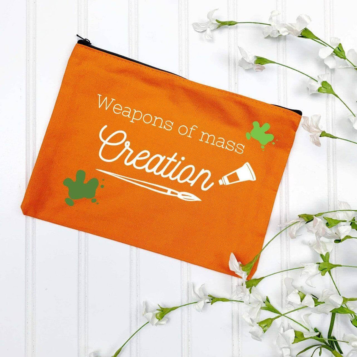 Red Weapons of Mass Creation pen and pencil case by Winks Design Studio, LLC, with a bold graphic design.
