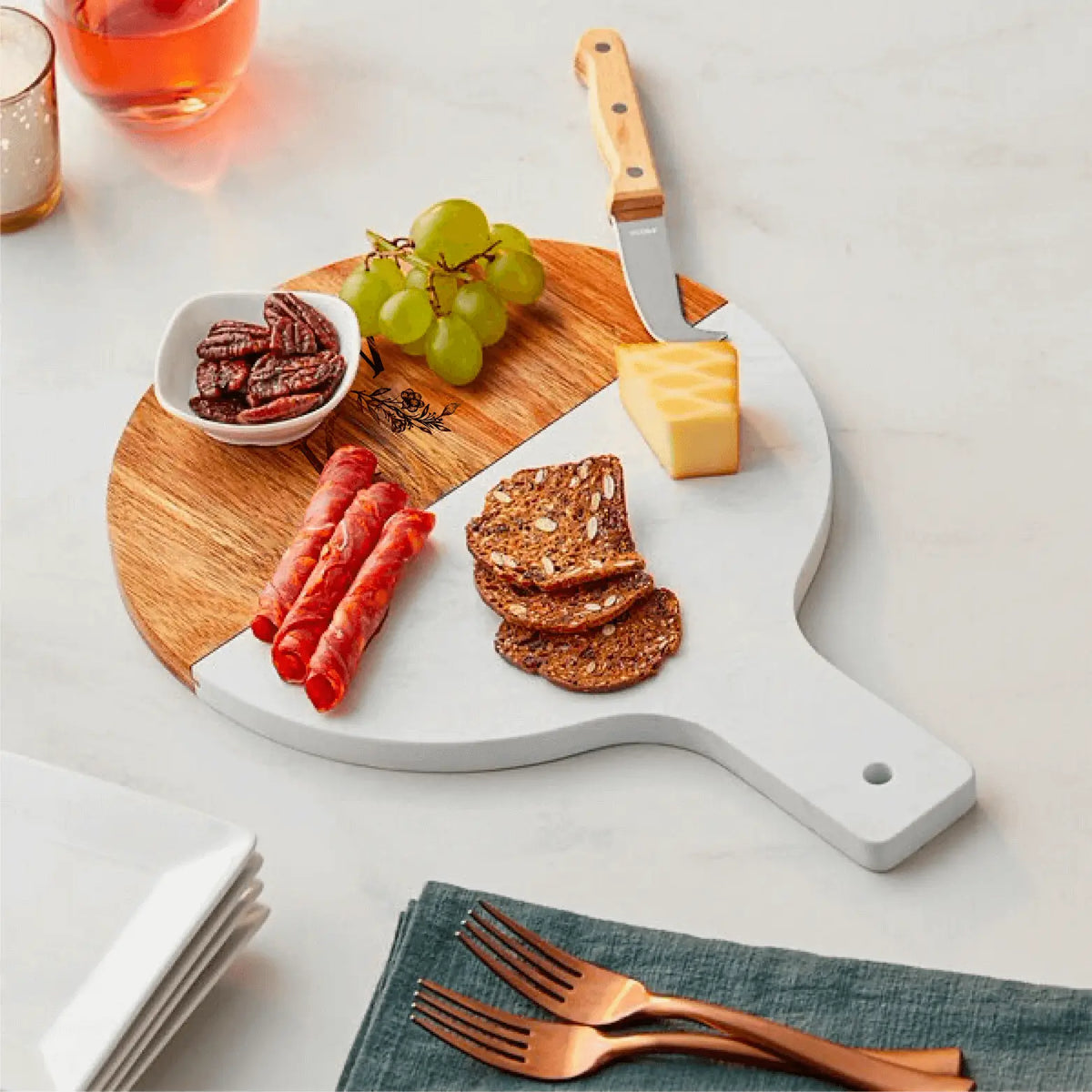 Personalized acacia wood and marble serving board with handle from Winks Design Studio, LLC, showcasing a stylish, natural wood and marble design.