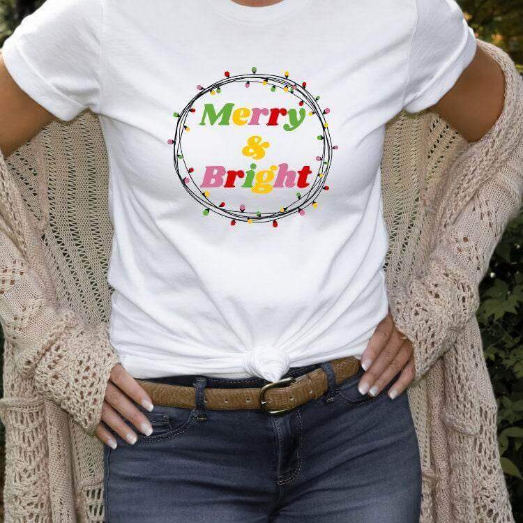Small Merry and Bright shirt from Winks Design Studio LLC, short-sleeve, casual top with festive print.