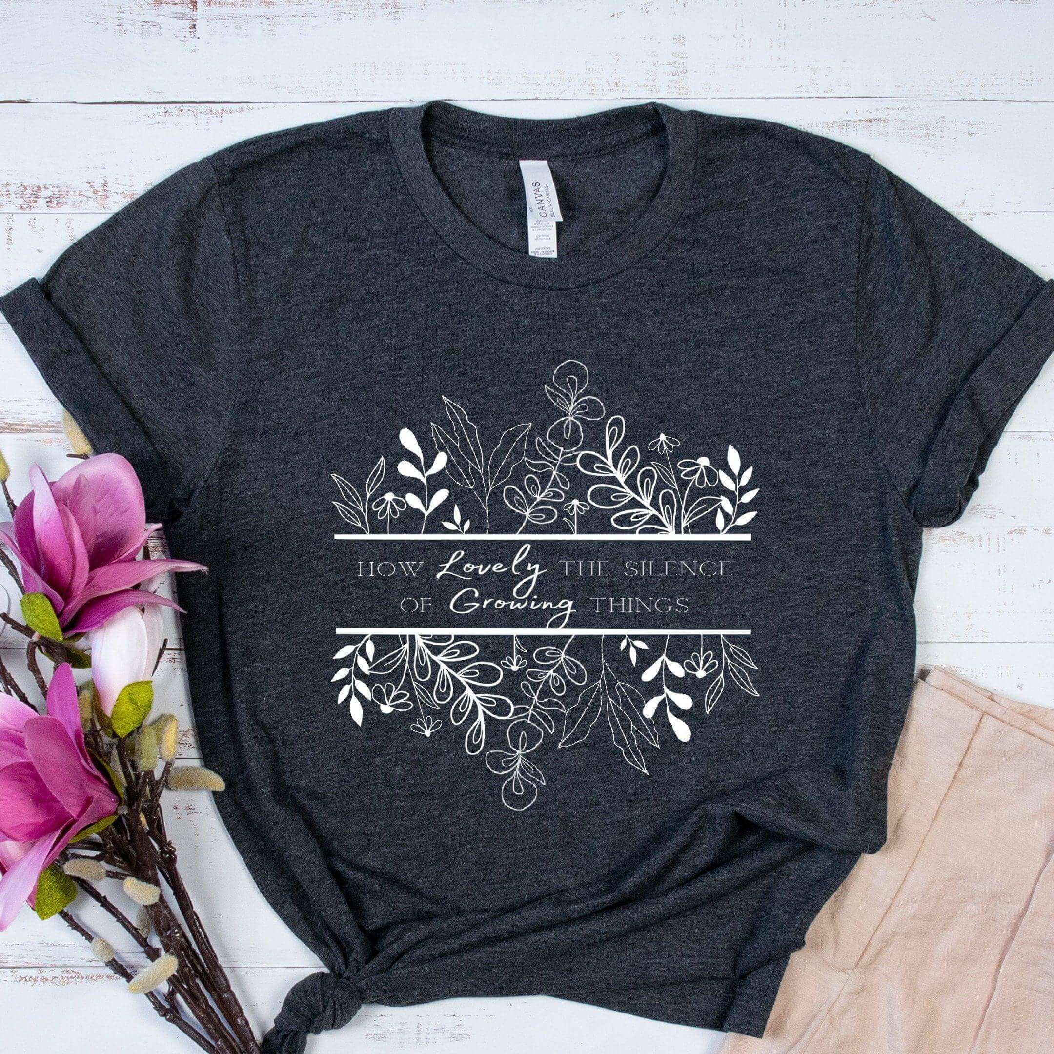 Black How Lovely the Silence of Growing Things T-shirt by Winks Design Studio, LLC, featuring a simple, stylish design.