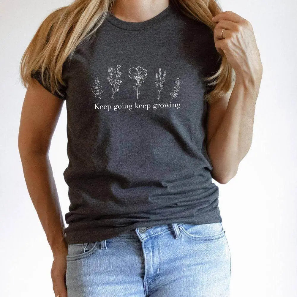 Black floral T-shirt from Winks Design Studio featuring "Keep Going Keep Growing" slogan, casual shirt for everyday wear.