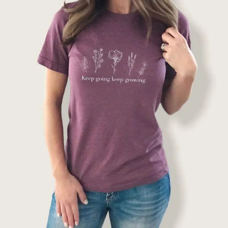 Black floral T-shirt from Winks Design Studio featuring the "Keep Going Keep Growing" slogan, casual shirts and tops for women.