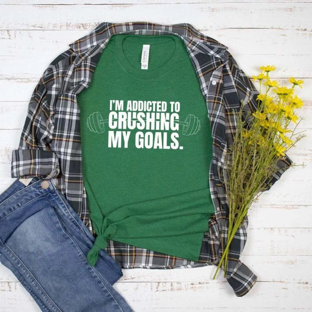 Black Crushing My Goals T-shirt by Winks Design Studio, LLC, displayed on a small-sized shirt with bold printed text.