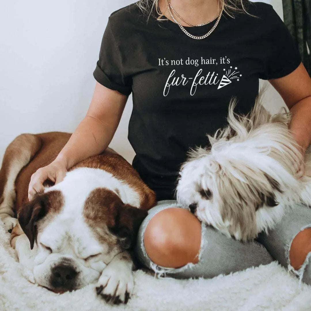 Black T-shirt from Winks Design Studio LLC featuring the playful "It’s Not Dog Hair, It’s Fur-fetti" print on the front.