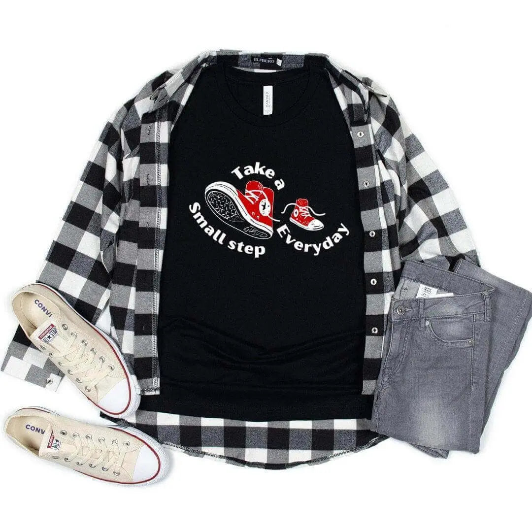 Black Take a Small Step Everyday T-Shirt by Winks Design Studio, LLC, featuring a casual fit and motivational message.