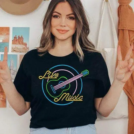 Winks Design Studio LLC T-shirt featuring a vibrant live music neon sign graphic on the front.