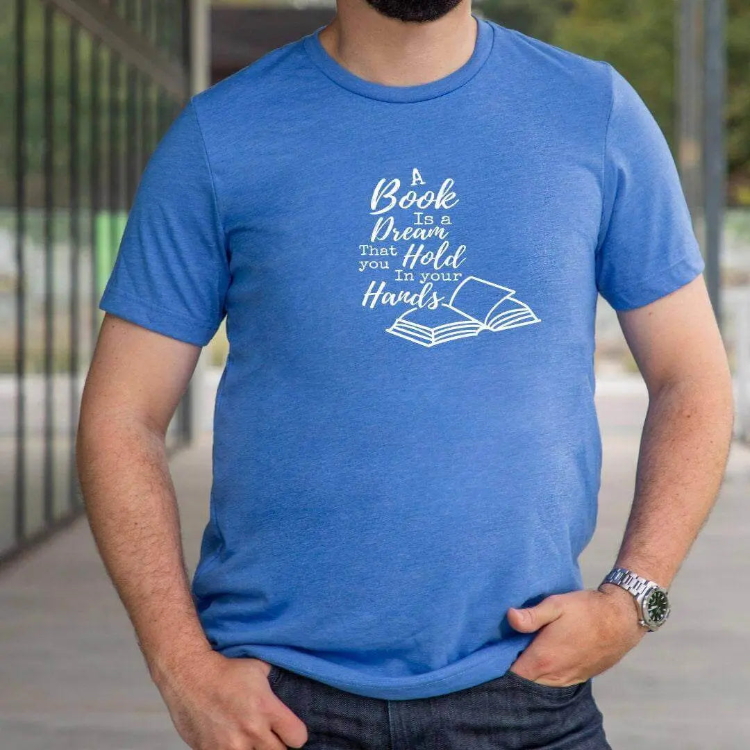Mauve t-shirt by Winks Design Studio LLC featuring a printed quote, "A Book Is A Dream That You Hold In Your Hands," displayed on the front.