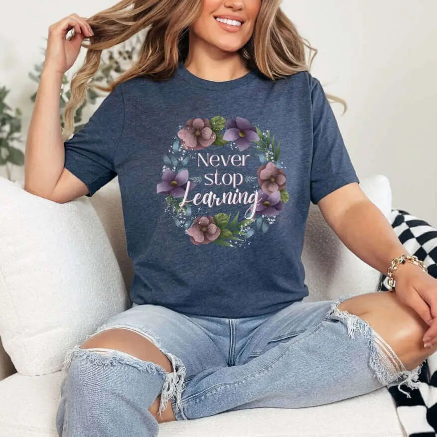 Winks Design Studio LLC Never Stop Learning T-shirt in small size featuring a motivational design on the front.