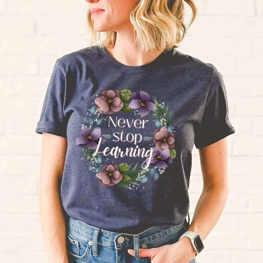 Winks Design Studio LLC Never Stop Learning T-shirt, black cotton tee with white text design, casual and comfortable.