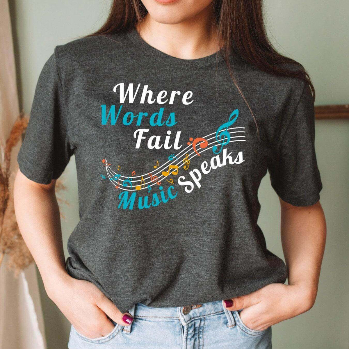 Winks Design Studio LLC white T-shirt with "Where Words Fail, Music Speaks" printed graphic, casual fit for music lovers.