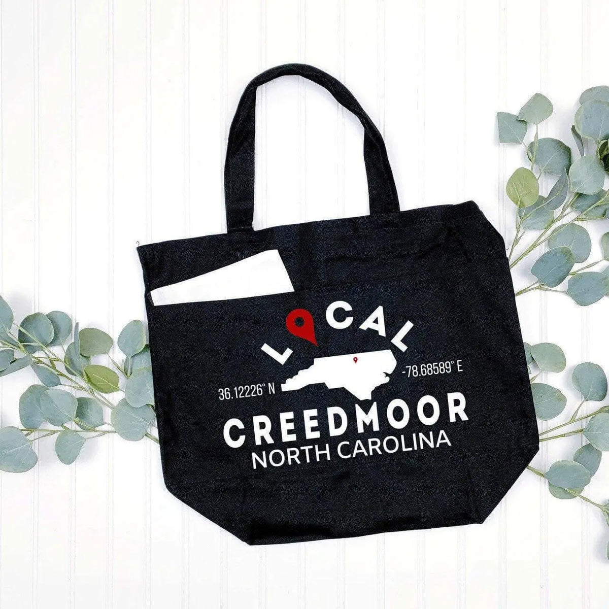 Black custom city and state tote bag by Winks Design Studio, LLC, featuring a personalized city and state design.