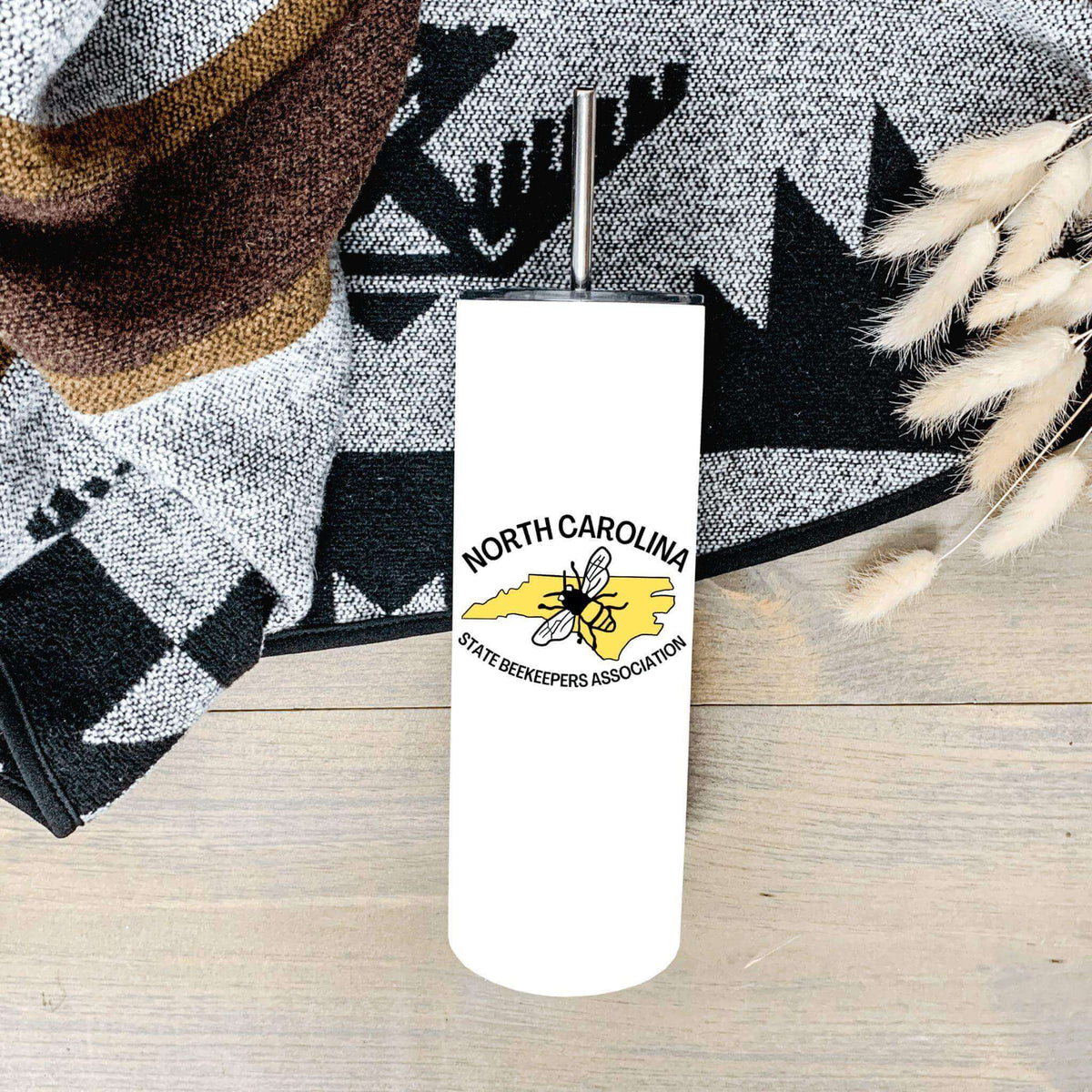 Winks Design Studio LLC NCSBA tumbler with straw, stainless steel body, and colorful design, perfect for beverages on the go.