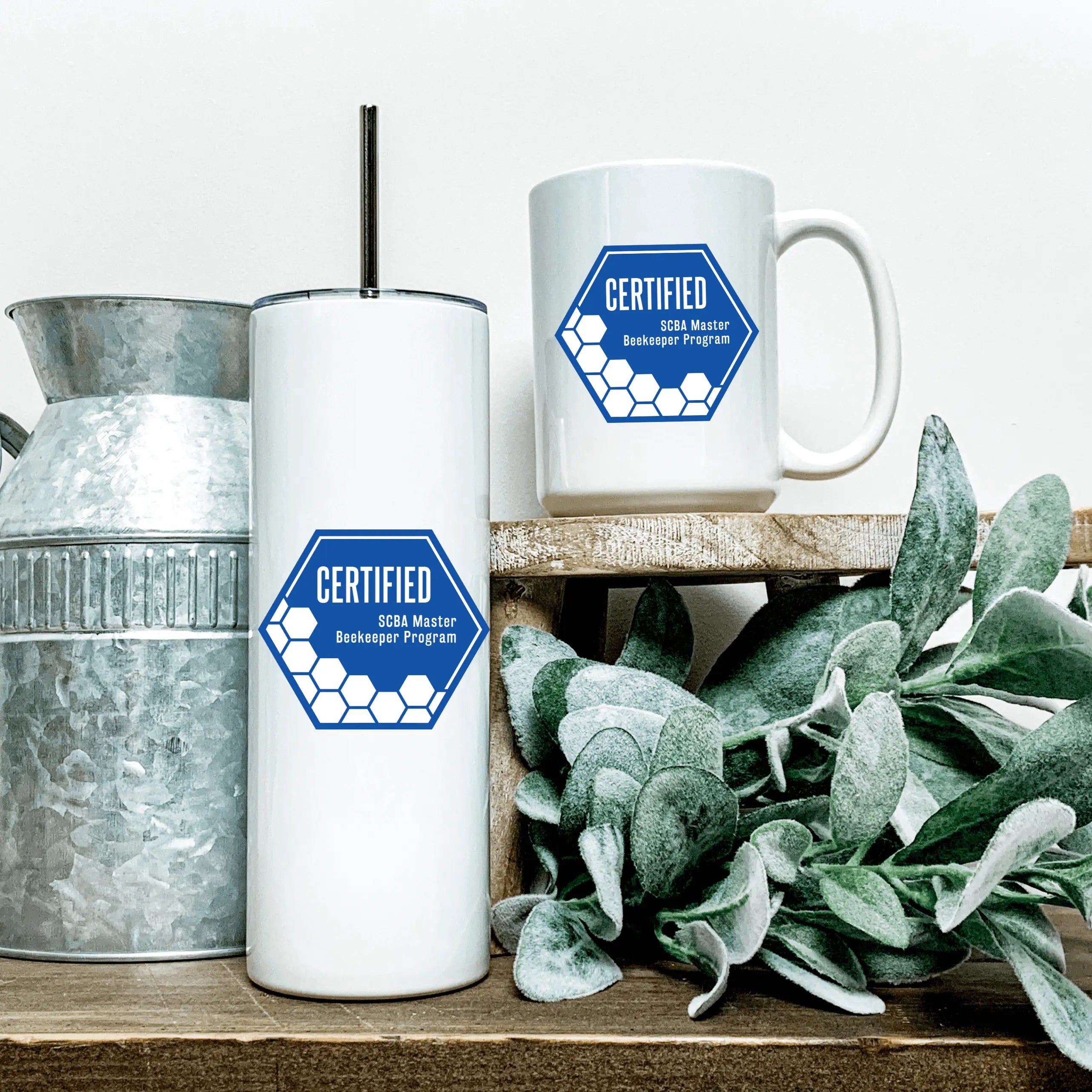 Winks Design Studio LLC SCBA Master Beekeeping Program 20 oz. tumbler with colorful bee and hive illustrations.