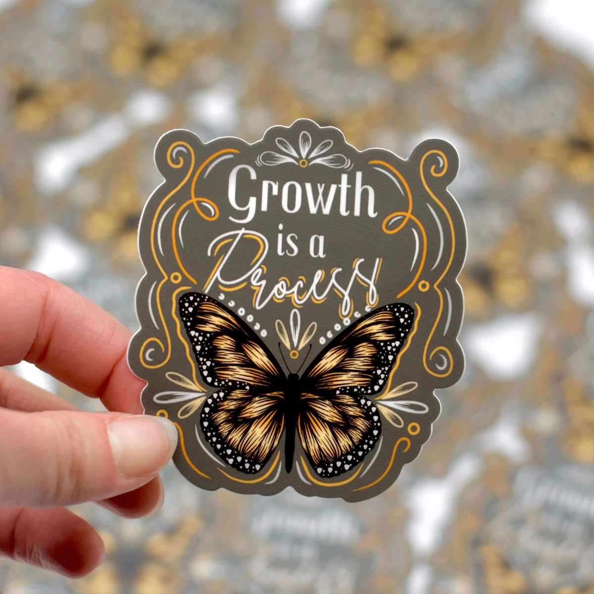 Vinyl sticker from Winks Design Studio with the phrase "Growth is a Process" in stylish lettering on a white background.