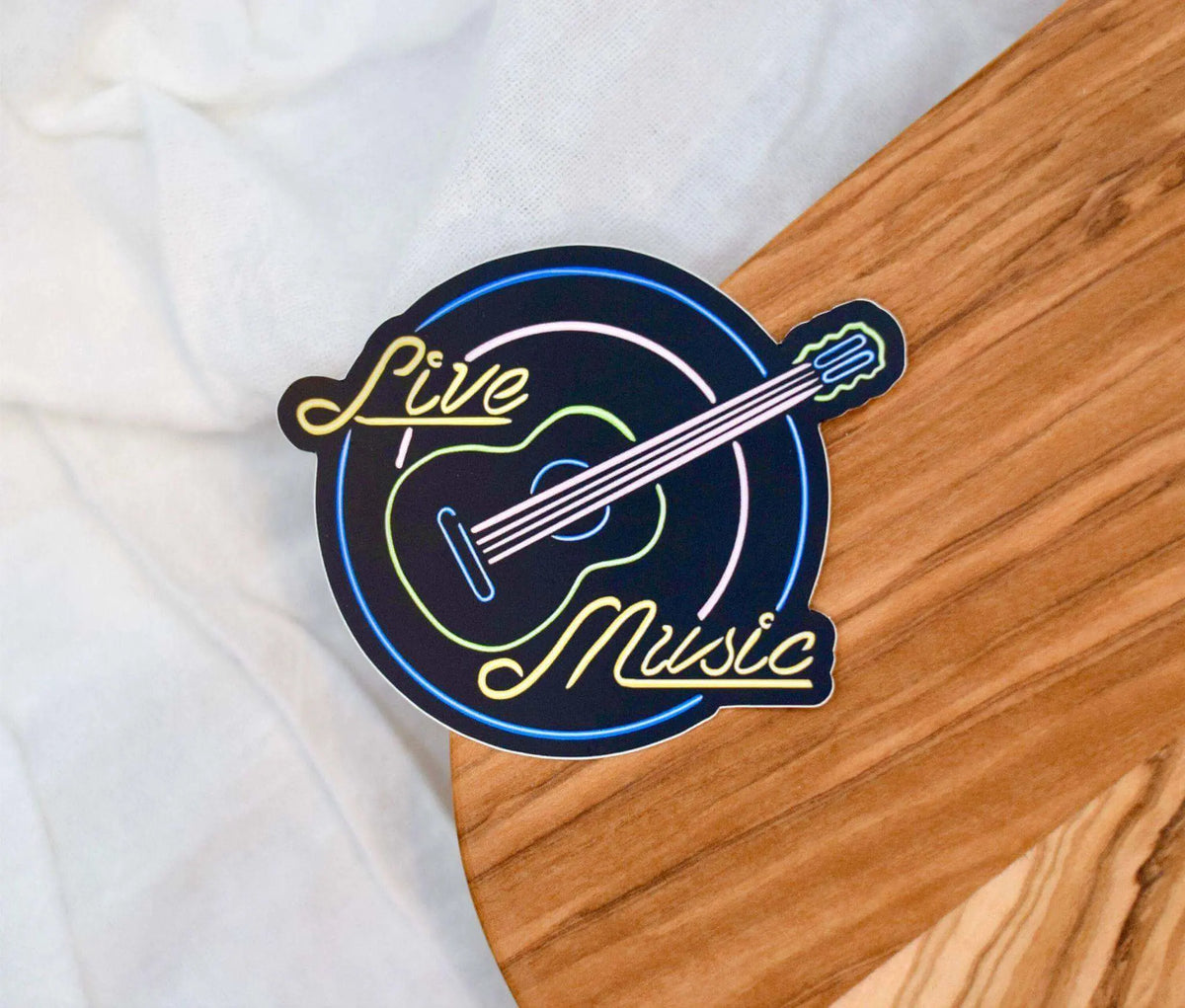 Live music neon sign waterproof vinyl sticker from Winks Design Studio, LLC, measuring 3x2.5 inches.