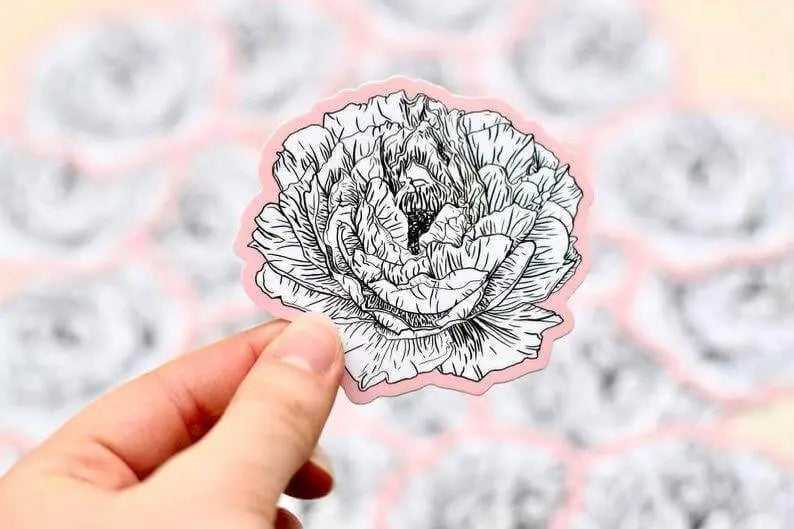 Pink peony flower vinyl sticker by Winks Design Studio, LLC, featuring a detailed pink peony blossom with green leaves.
