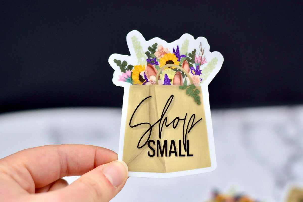 Vinyl Shop Small sticker from Winks Design Studio, LLC with bold black lettering on clear background.