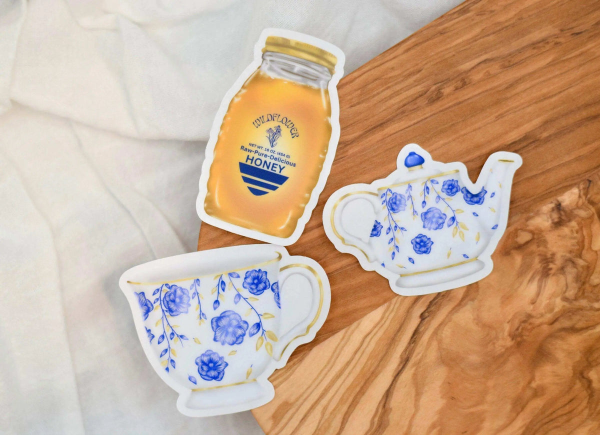 Set of colorful vinyl tea party stickers from Winks Design Studio, LLC featuring teacups, teapots, and tea party-themed designs.