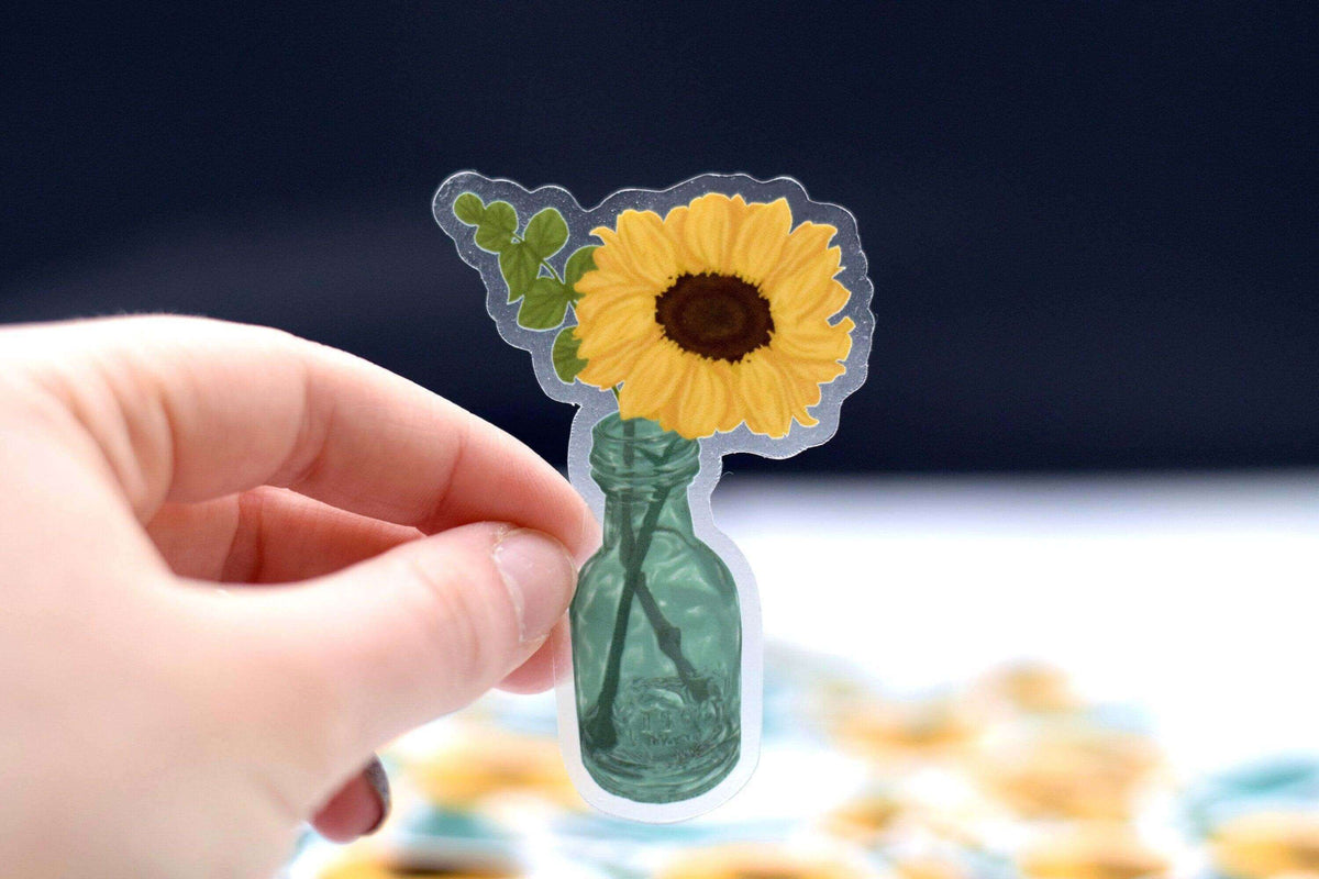 Clear vinyl sunflower sticker by Winks Design Studio, LLC featuring a vibrant sunflower design on transparent background.