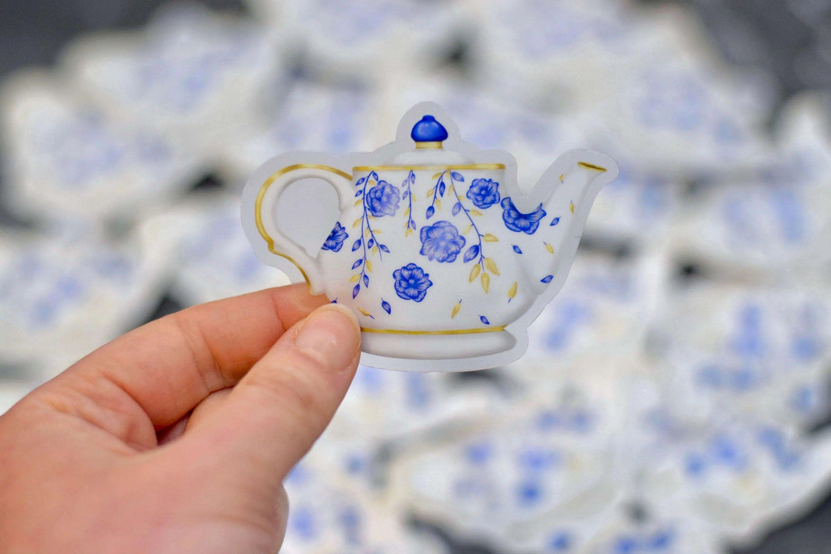 Vintage floral teapot vinyl sticker by Winks Design Studio, LLC, featuring detailed floral design on a charming teapot illustration.
