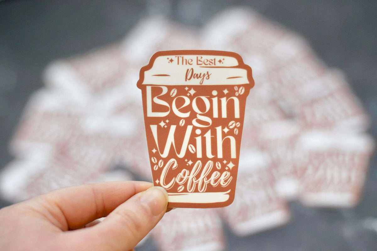 Vinyl sticker featuring the phrase "The Best Days Begin with Coffee" by Winks Design Studio, LLC, with coffee cup illustration.