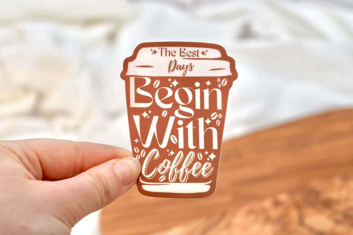 Vinyl sticker from Winks Design Studio LLC featuring the phrase "The Best Days Begin with Coffee" in stylish lettering.