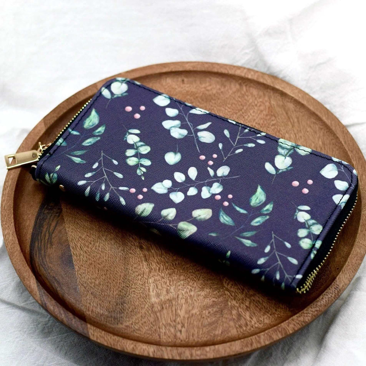 Eucalyptus leaves women’s wallet by Winks Design Studio, LLC featuring a large zipper design and wristlet strap.