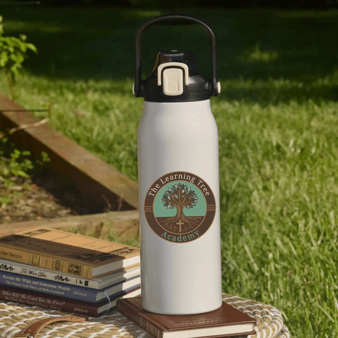 Winks Design Studio LLC 57oz water tumbler featuring The Learning Tree Academy logo and design, with a clear lid and stainless steel body.