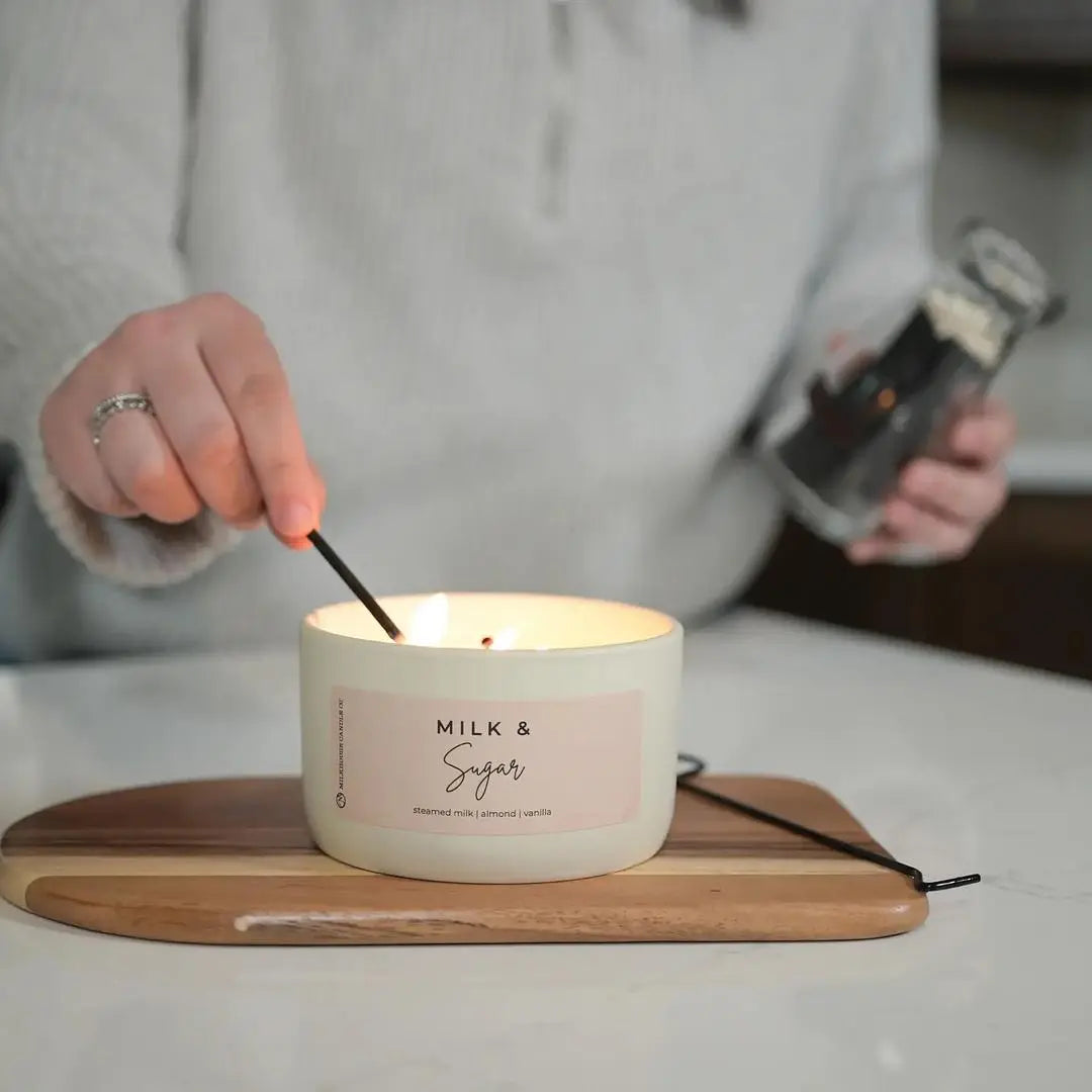A person lighting a candle.