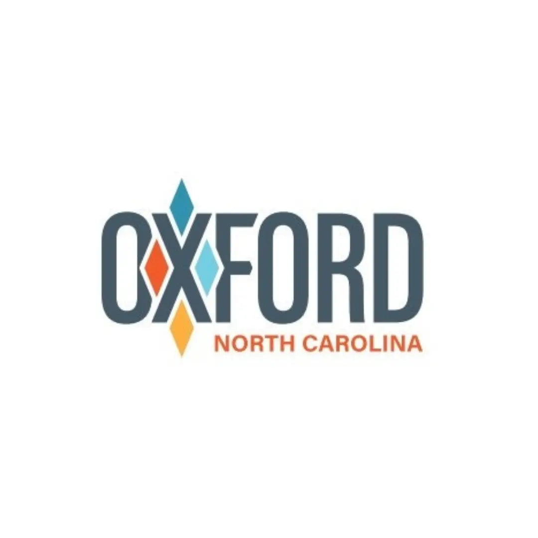 Oxford North Carolina text logo in peach and green colors.