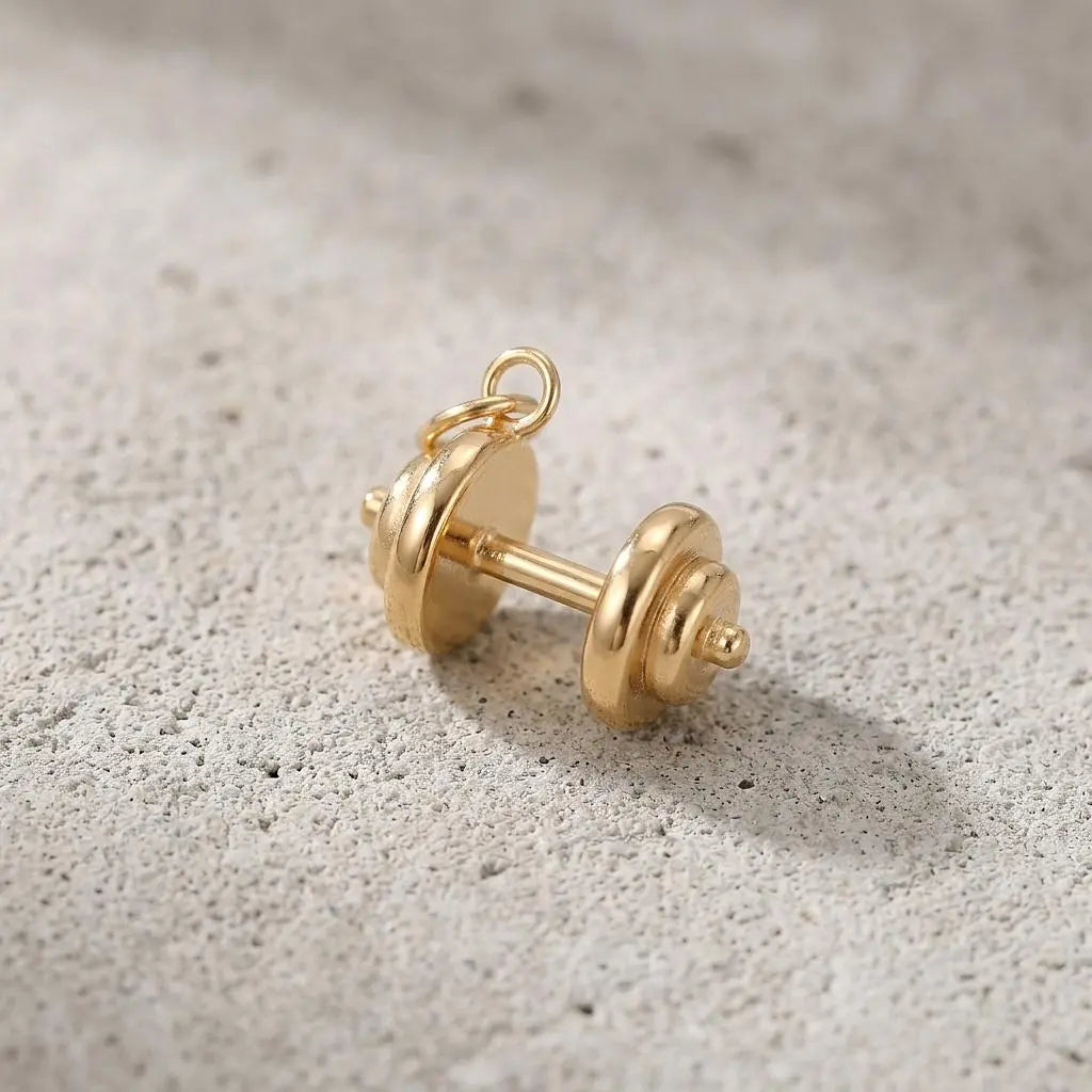 Gold dumbbell charm jewelry from Winks Design Studio, LLC, featuring a detailed gold-colored fitness-themed charm.