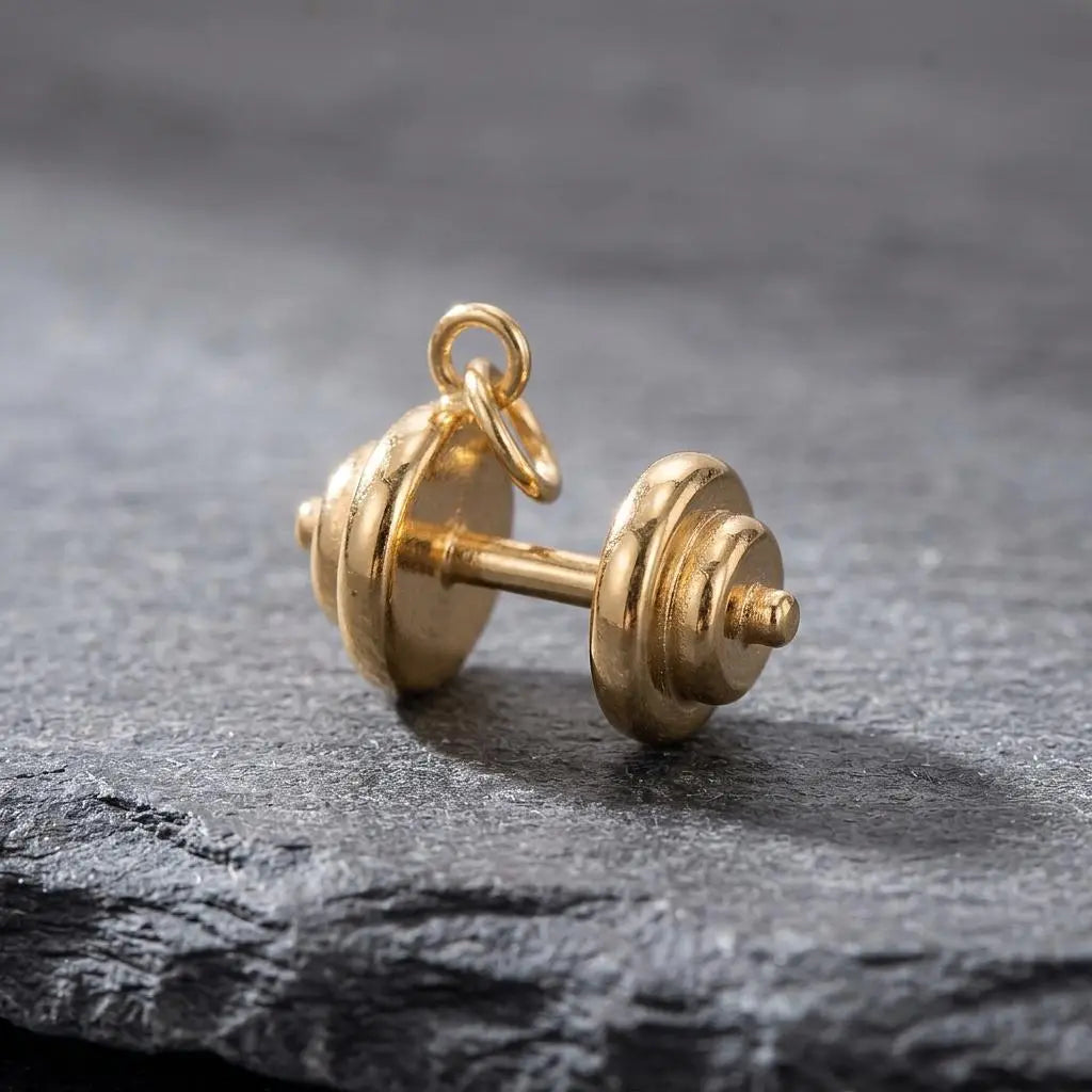 Gold dumbbell charm jewelry from Winks Design Studio, LLC, featuring a detailed gold dumbbell pendant.