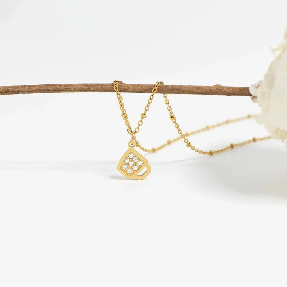18K gold coffee cup charm by Winks Design Studio, LLC, featuring a detailed miniature coffee cup pendant.