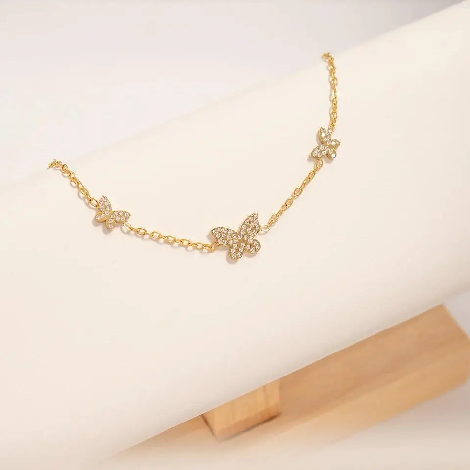 Butterfly bracelet by Winks Design Studio featuring 18K gold stainless steel charm with delicate butterfly design.