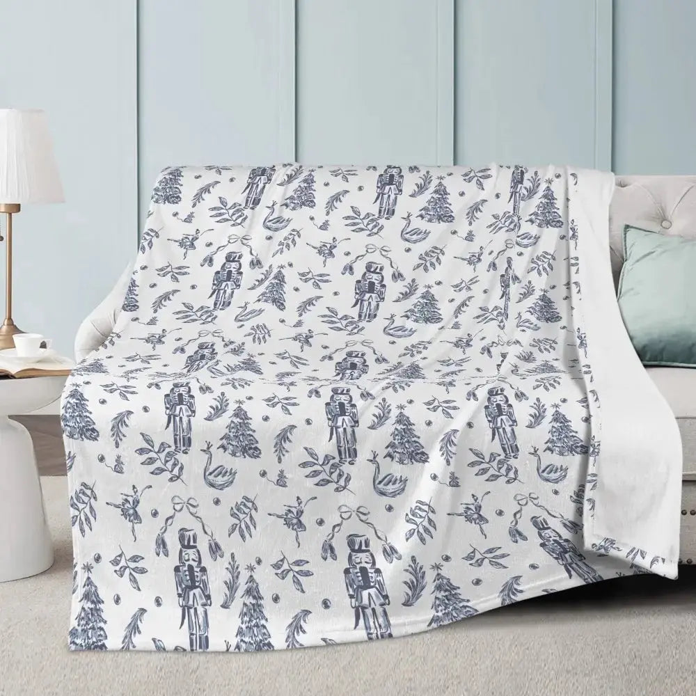 Winks Design Studio LLC Elegant Nutcracker Christmas blanket with festive holiday design and cozy fabric, perfect for winter decor.