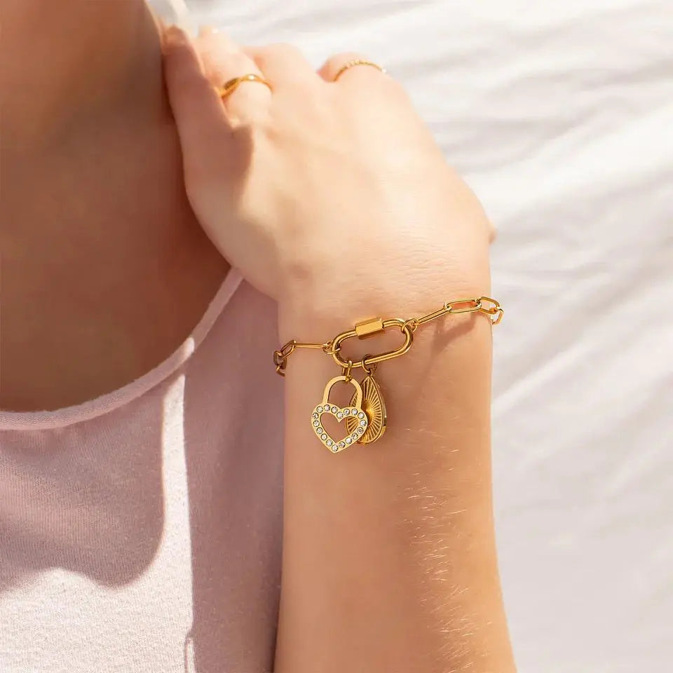 18K gold paperclip carabiner bracelet by Winks Design Studio, LLC, featuring sleek, modern gold links on a stylish bracelet.