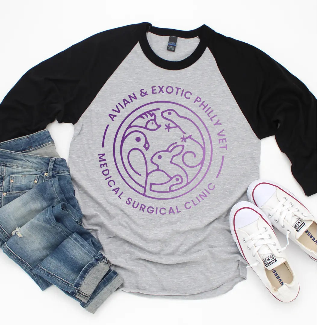 Avian Exotic raglan baseball T-shirt by Winks Design Studio, LLC featuring colorful bird and animal prints on the front.